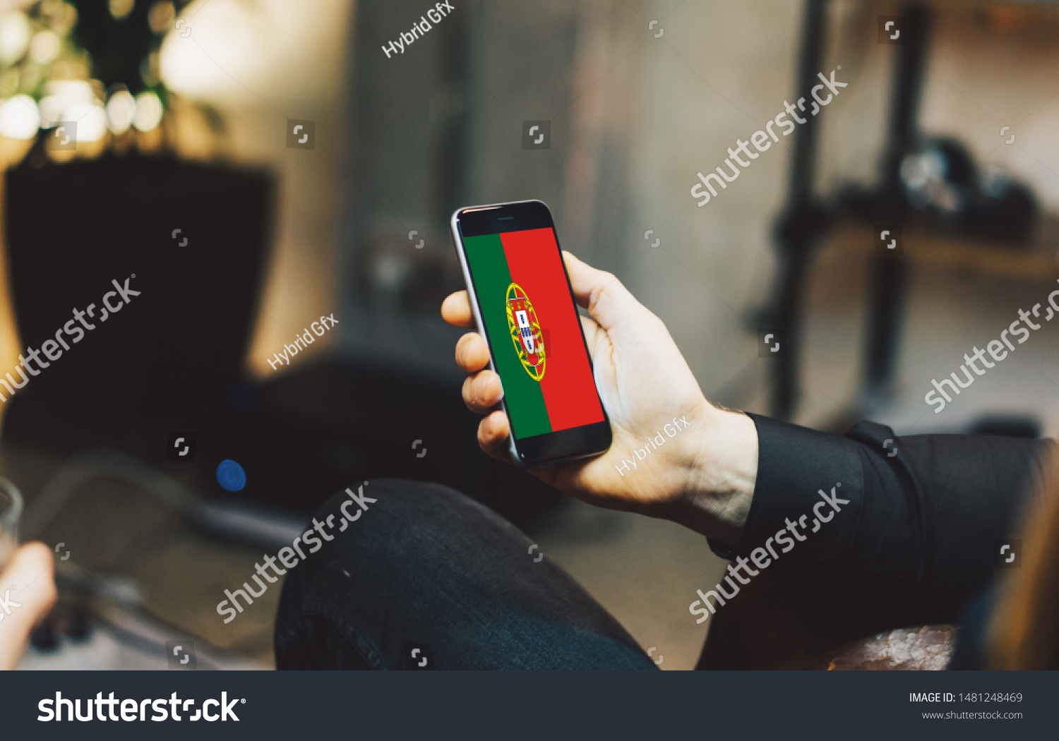 Man holding Smartphone with Flag of Portugal. Portugal Flag on Mobile Screen. #1481248469