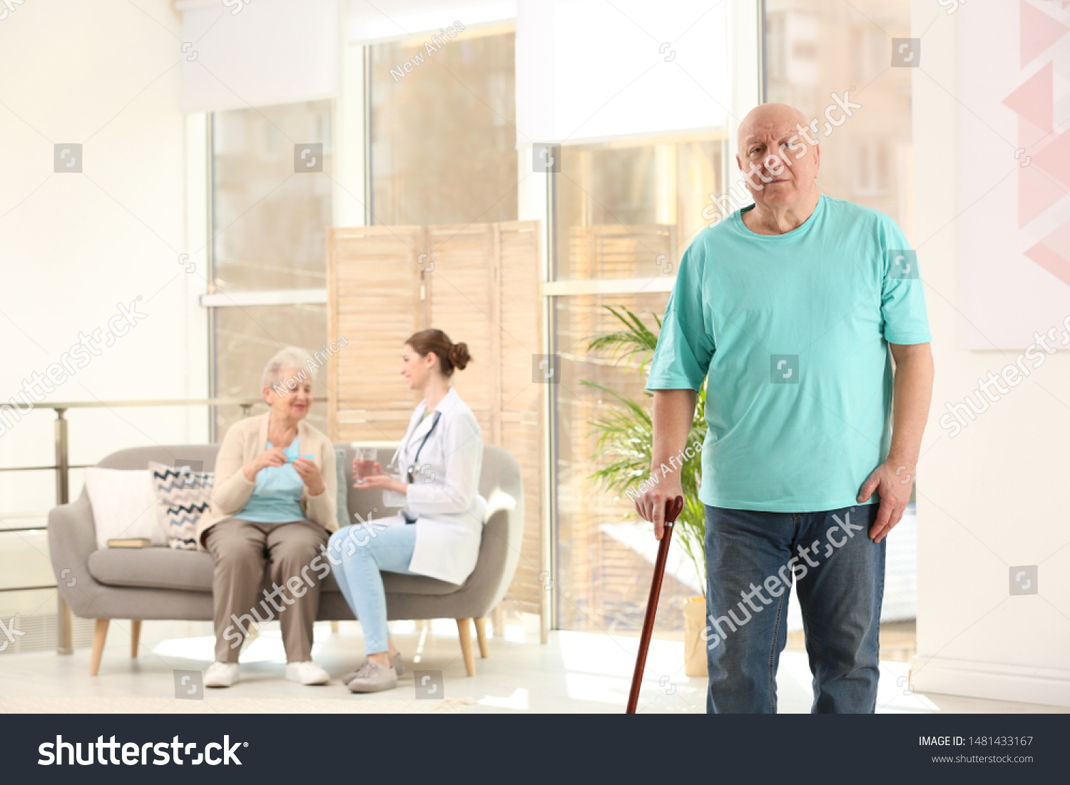 Elderly man with cane in nursing home, space for text. Assisting senior generation #1481433167