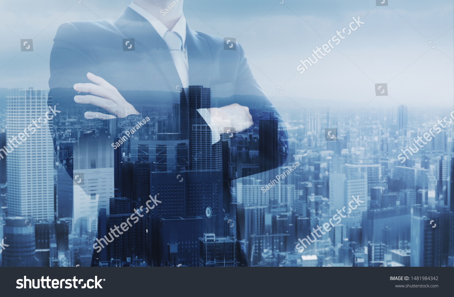 Businessman with arm crossed, double exposure futuristic city #1481984342