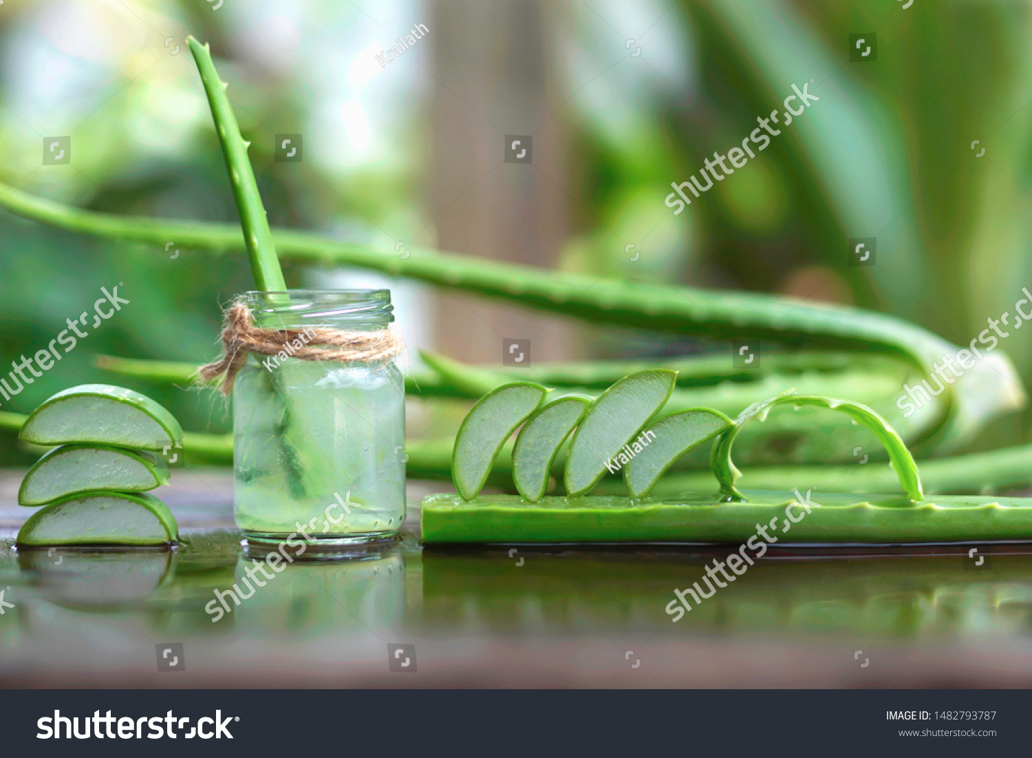 Aloe vera leaves and a glass of water laid on the wooden floor #1482793787