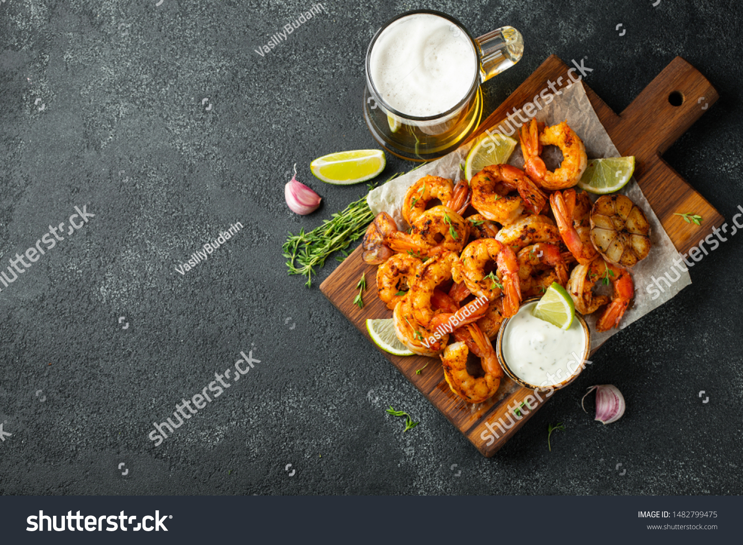 Grilled shrimps or prawns served with lime, garlic and white sauce on a dark concrete background. Seafood. Top view with copy space. Flat lay #1482799475