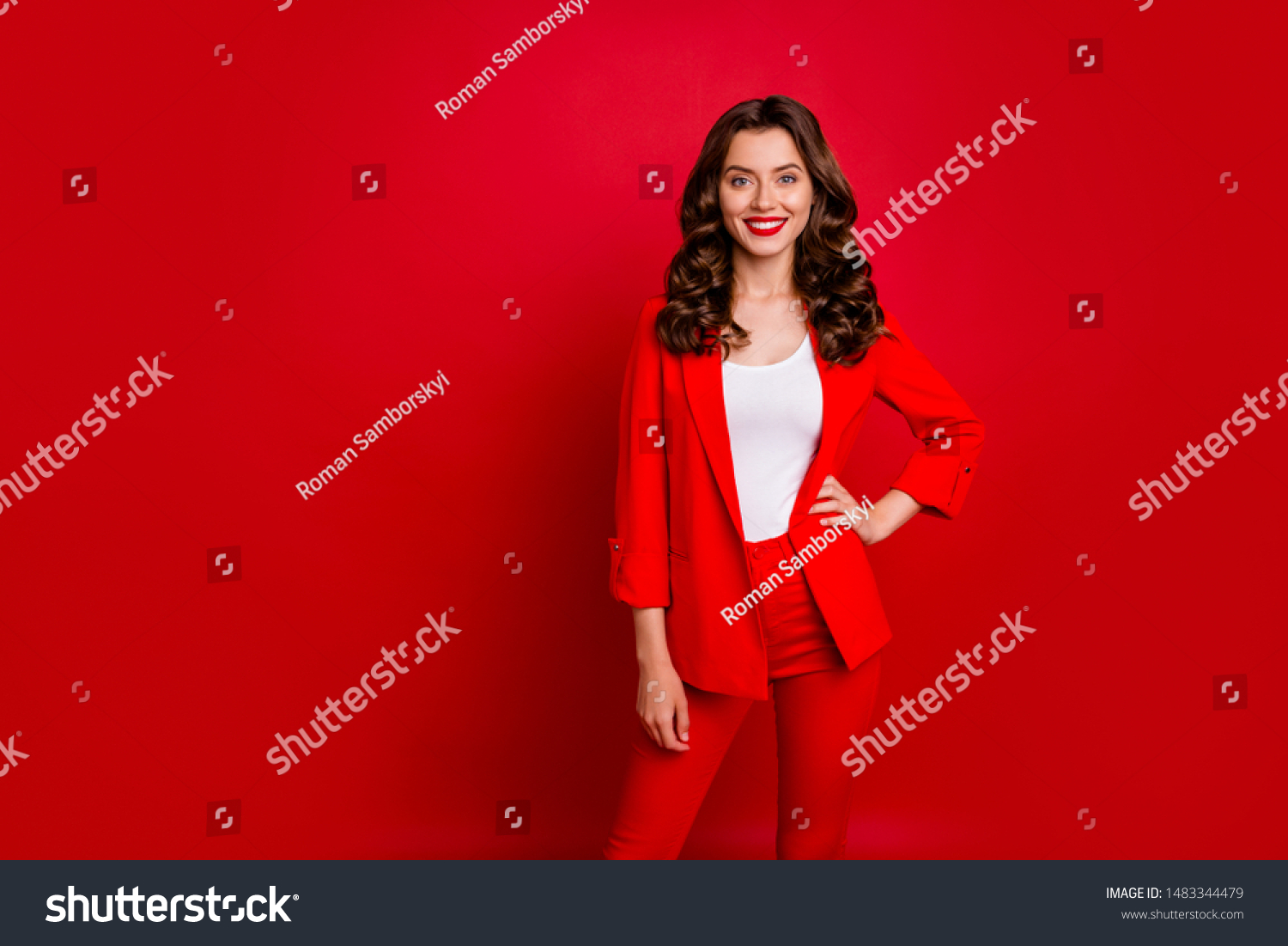 Portrait of elegant lady looking with toothy smile wearing suit isolated over red background #1483344479