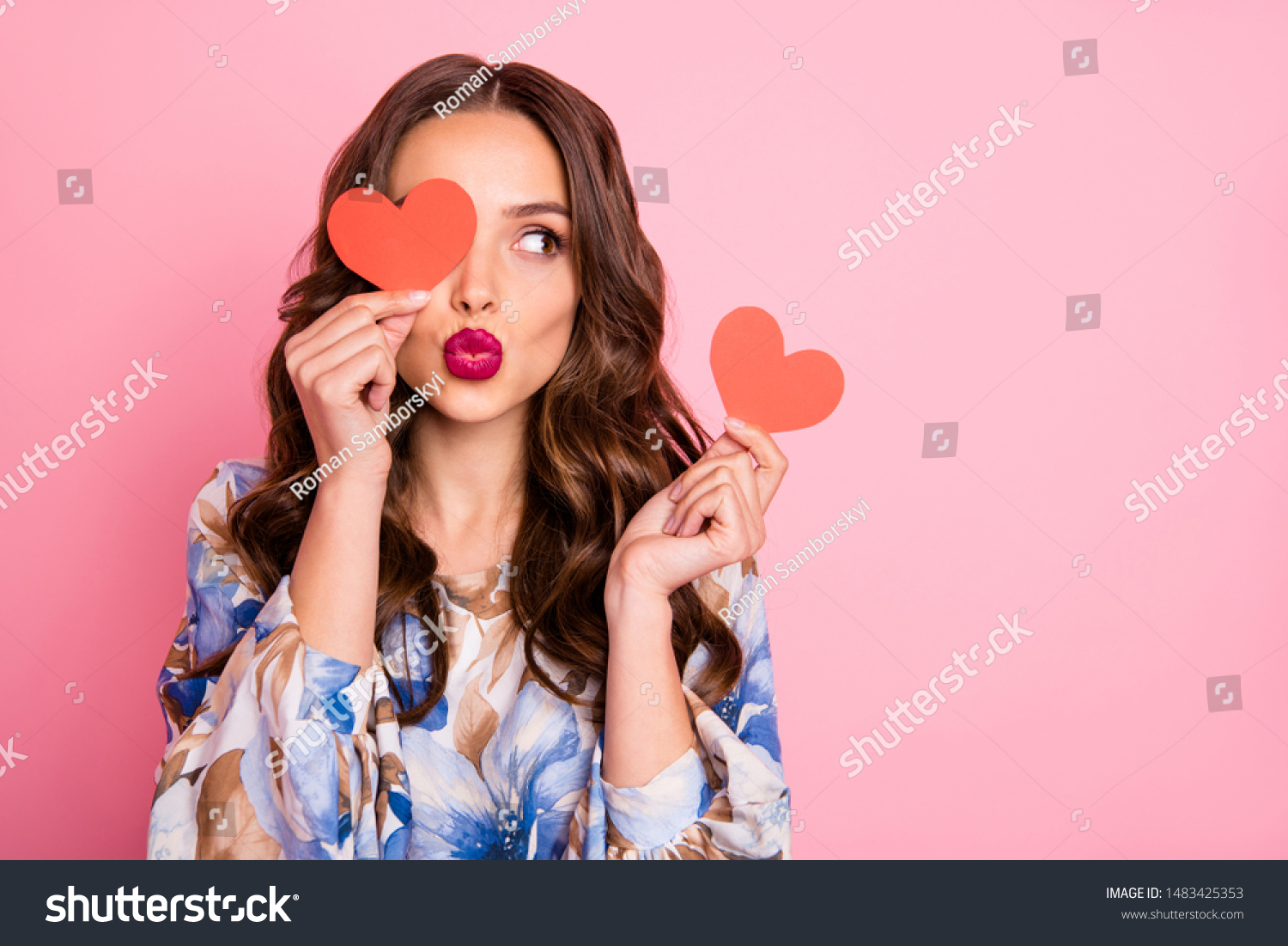 Close-up portrait of her she nice-looking attractive lovely coquettish cheerful cheery wavy-haired girl holding in hands two small little heart sending you kiss isolated over pink pastel background #1483425353