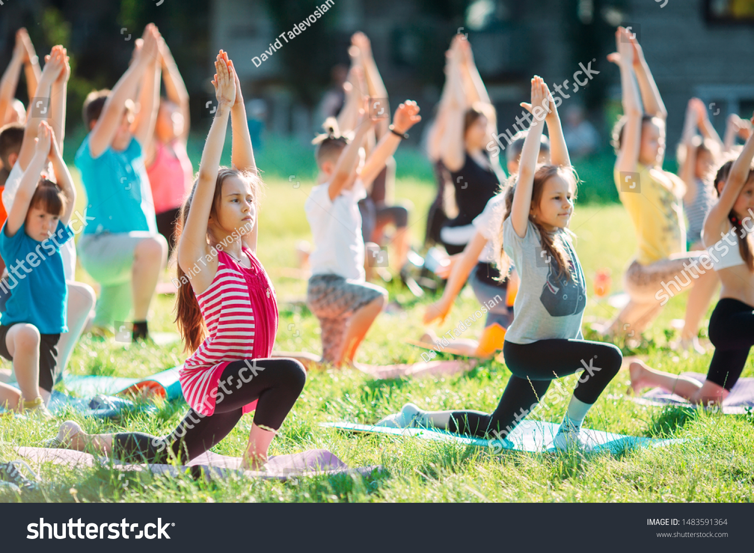 Yoga classes outside on the open air. Kids Yoga #1483591364