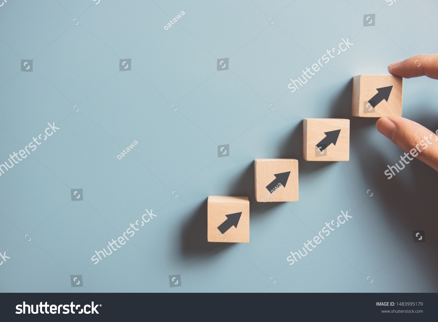 Business concept growth success process, Close up Woman hand arranging wood block stacking as step stair on paper blue background, copy space. #1483995179