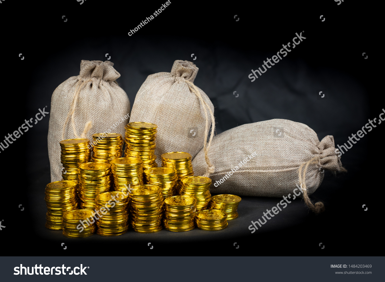 Stacking gold coin in treasure stack at black background #1484203469