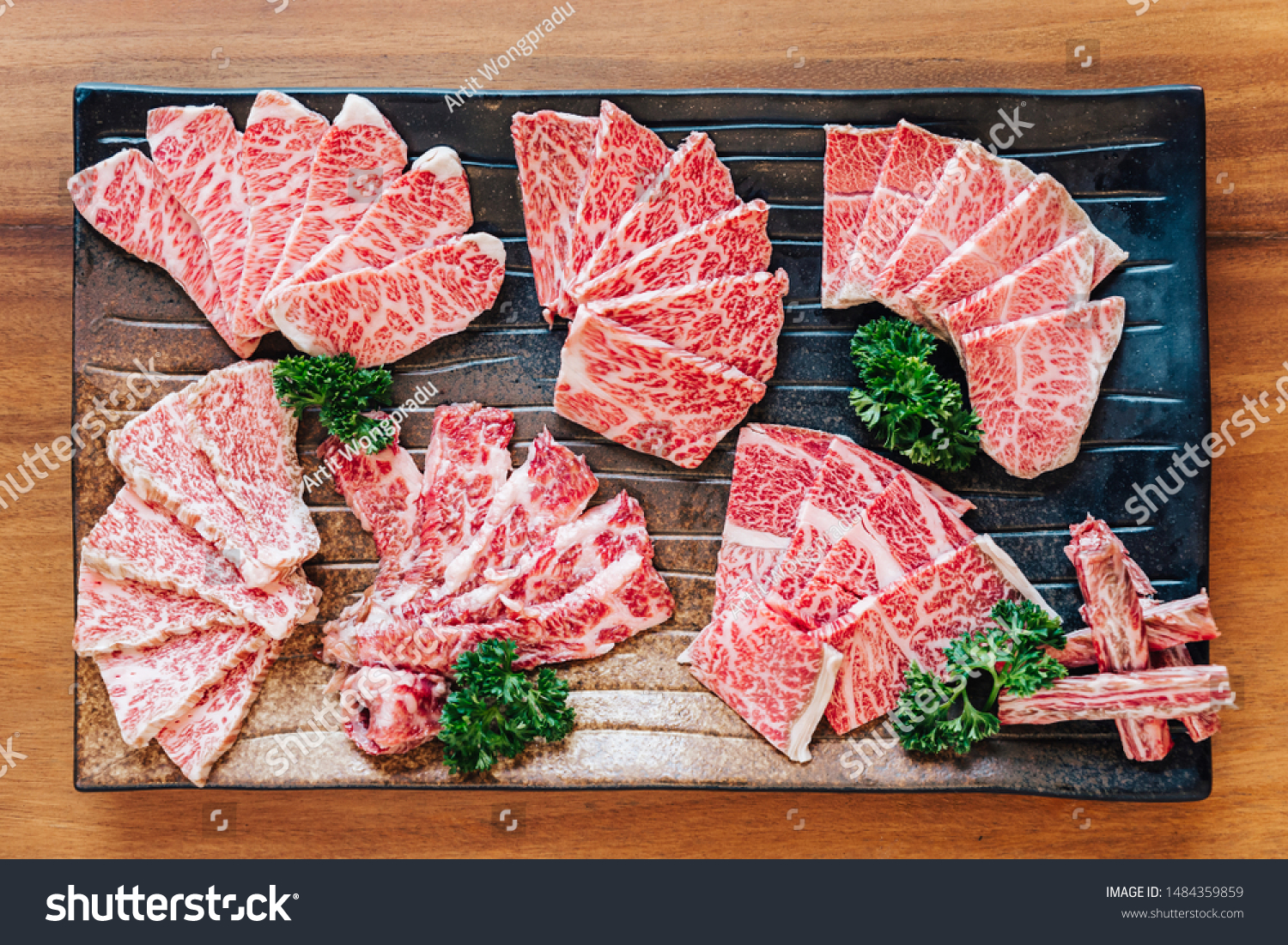 Top view of Premium Rare Slices many parts of Wagyu A5 beef with high-marbled texture on stone plate served for Yakiniku (Grilled Meat). #1484359859
