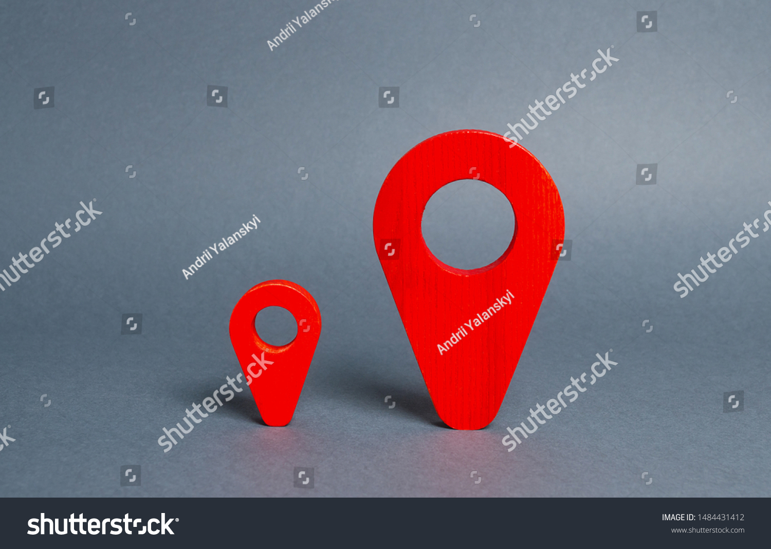 Small and large red navigational location indicators. The concept of a more significant and popular place. Competition. Arrival Point Measure distance and build a route. #1484431412