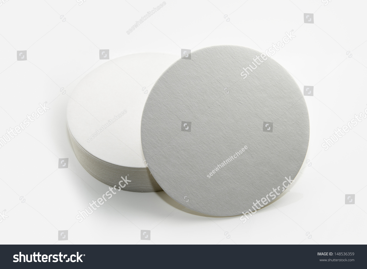 Stack of new beer coasters isolated on a white background. Add your own design or logo. #148536359