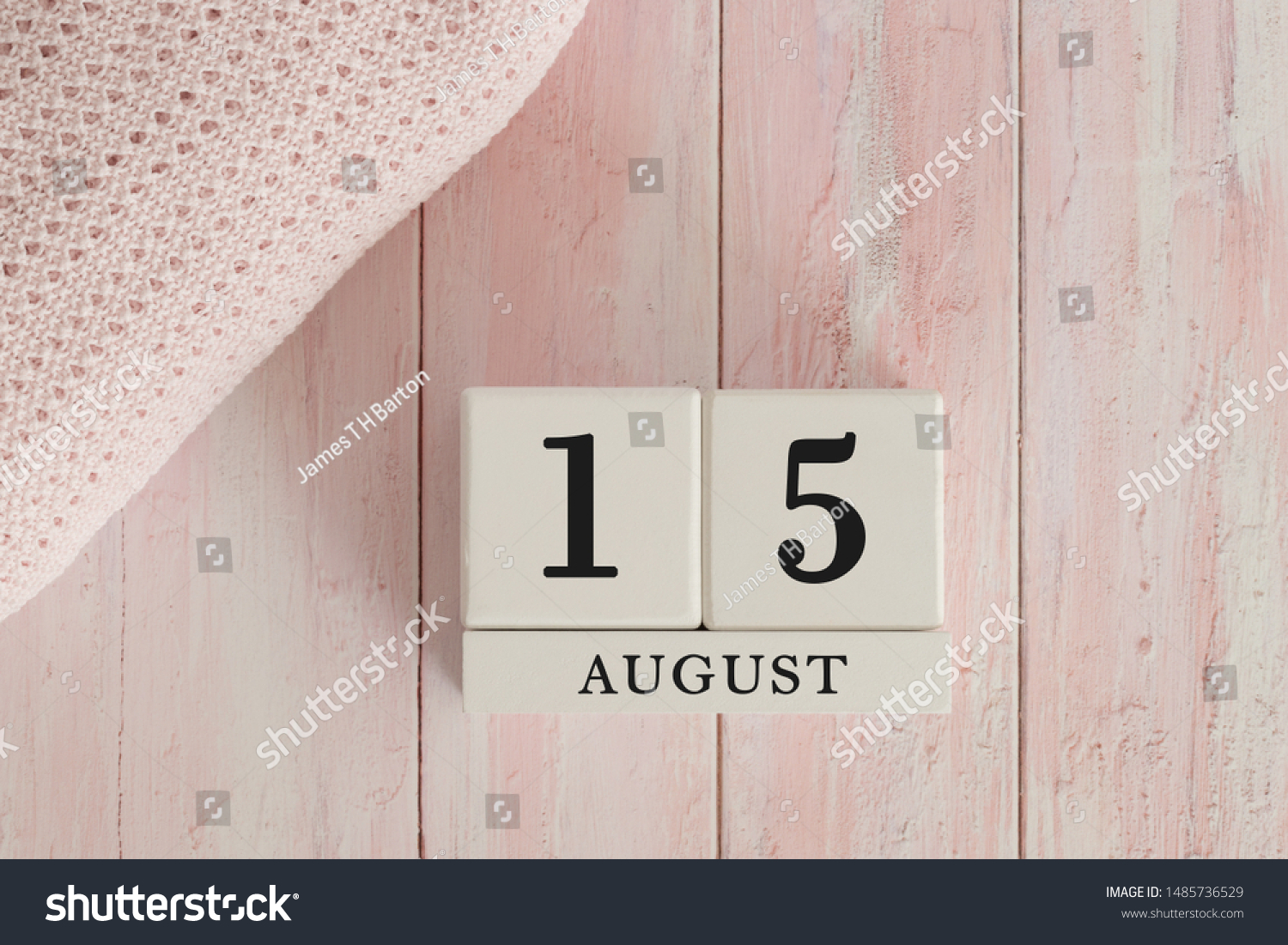 15 August Date on Cubes. Date on painted pink wood, next to baby blanket. Theme of baby due dates and birth dates. #1485736529