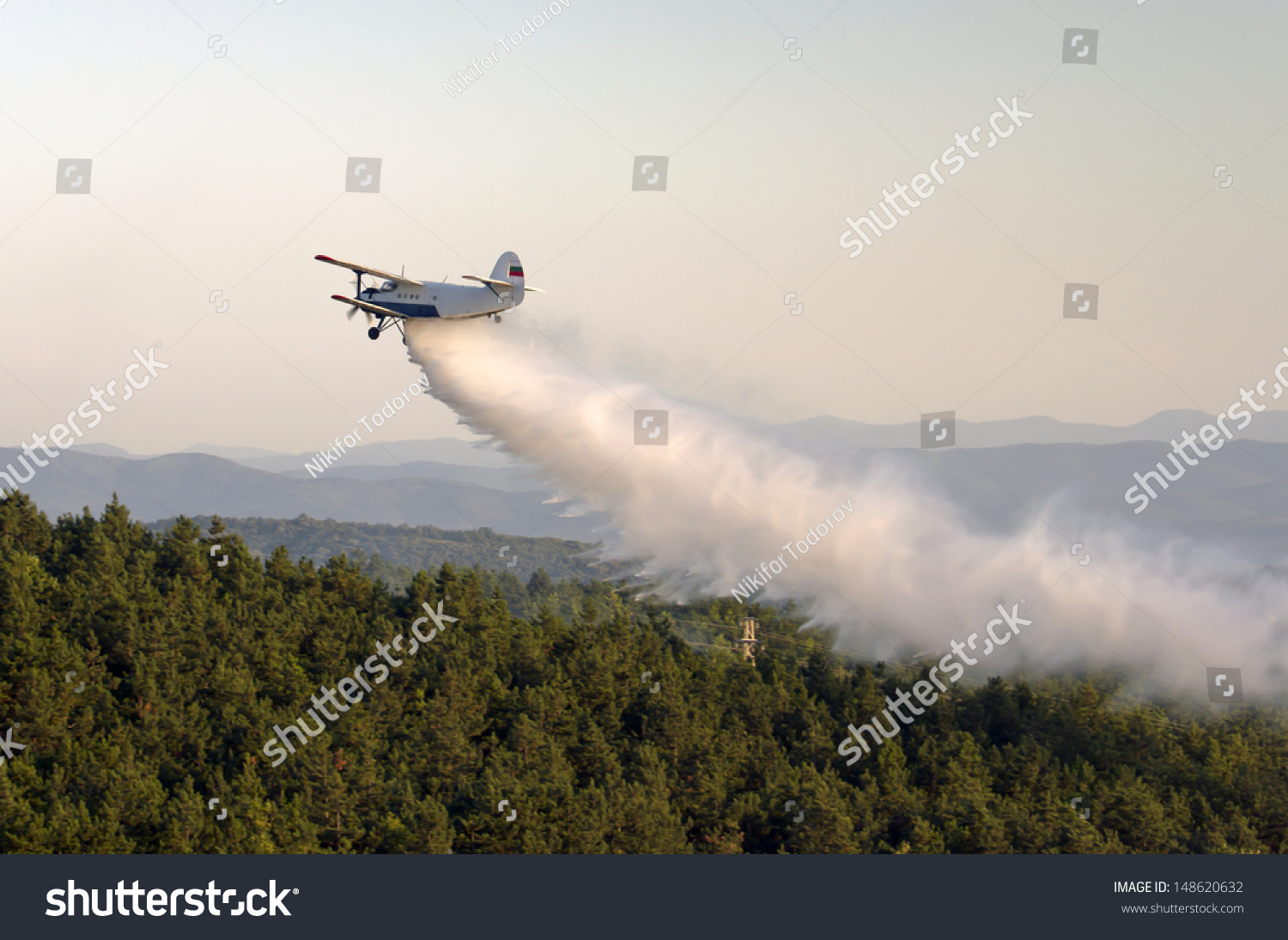 Fire-fighting aircraft drops water - Royalty Free Stock Photo 148620632 ...