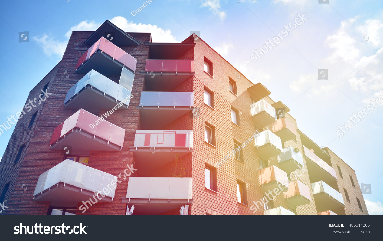 Modern apartment building detail, glass surface with sunlight #1486614206