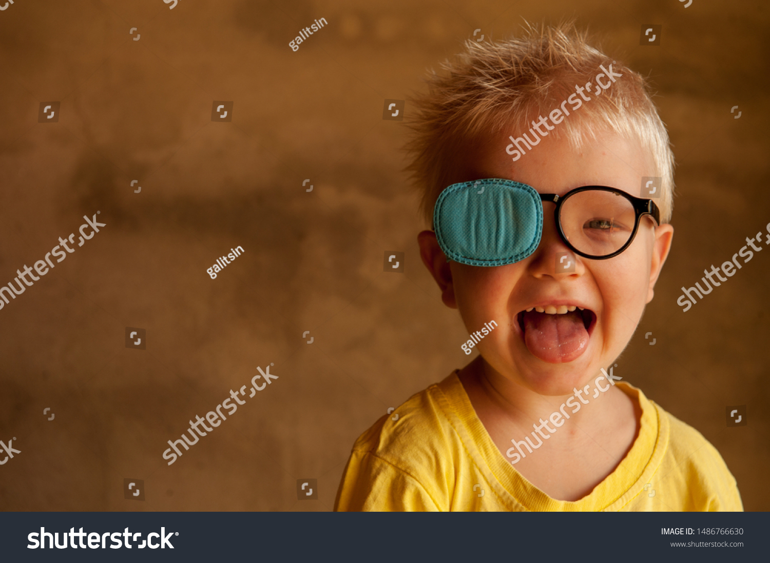 Portrait of funny child in new glasses with patch for correcting squint 
Ortopad Boys Eye Patches nozzle for glasses for treatment of strabismus (lazy eye) #1486766630