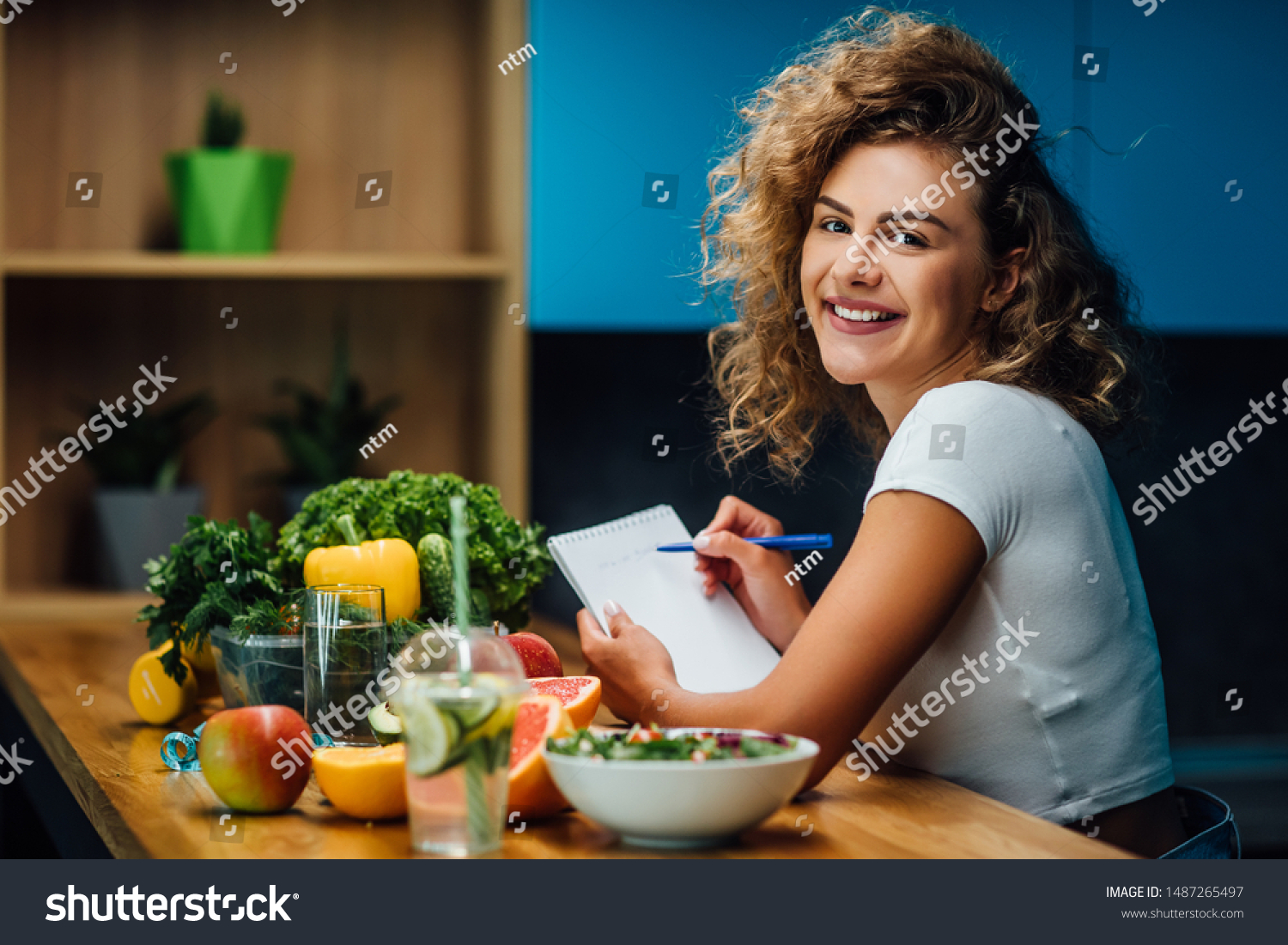 Nutritionist working in office. Doctor writing diet plan on table and using vegetables. Sport trainer. Lifestyle. #1487265497