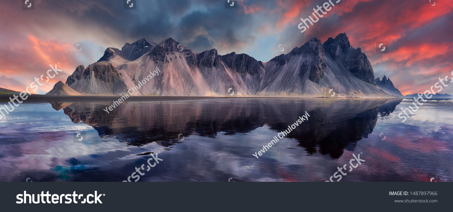 Vestrahorn mountaine on Stokksnes cape in Iceland during sunset with reflections. Amazing Iceland nature seascape. popular tourist attraction. Best famouse travel locations. Scenic Image of Iceland #1487897966