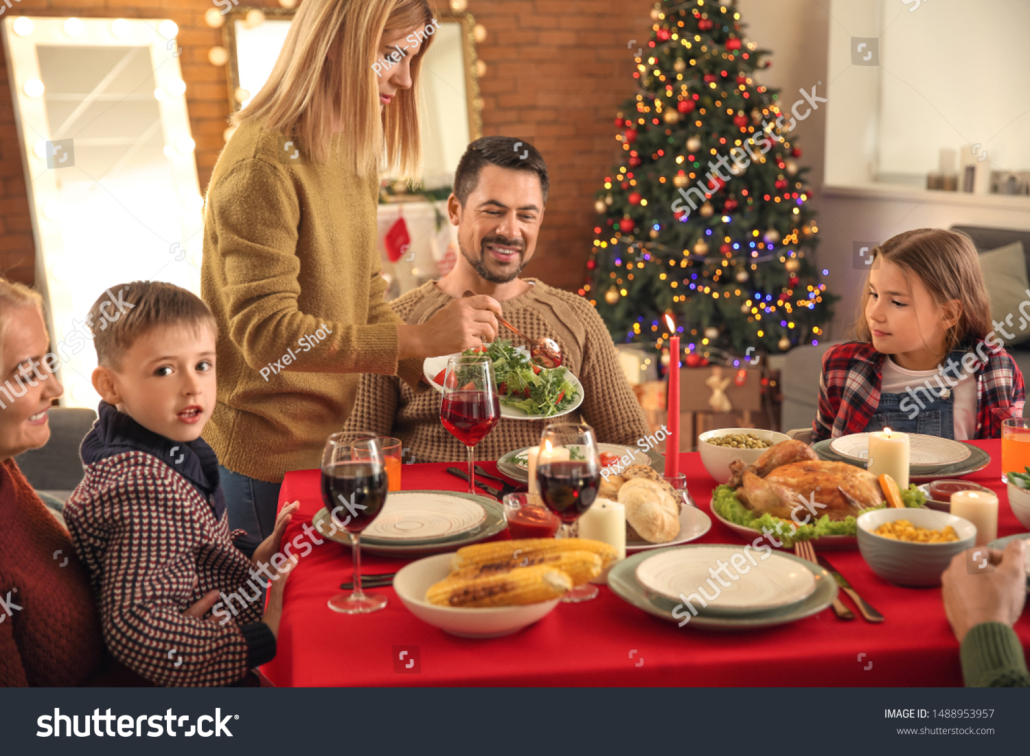 Happy family having Christmas dinner at home #1488953957