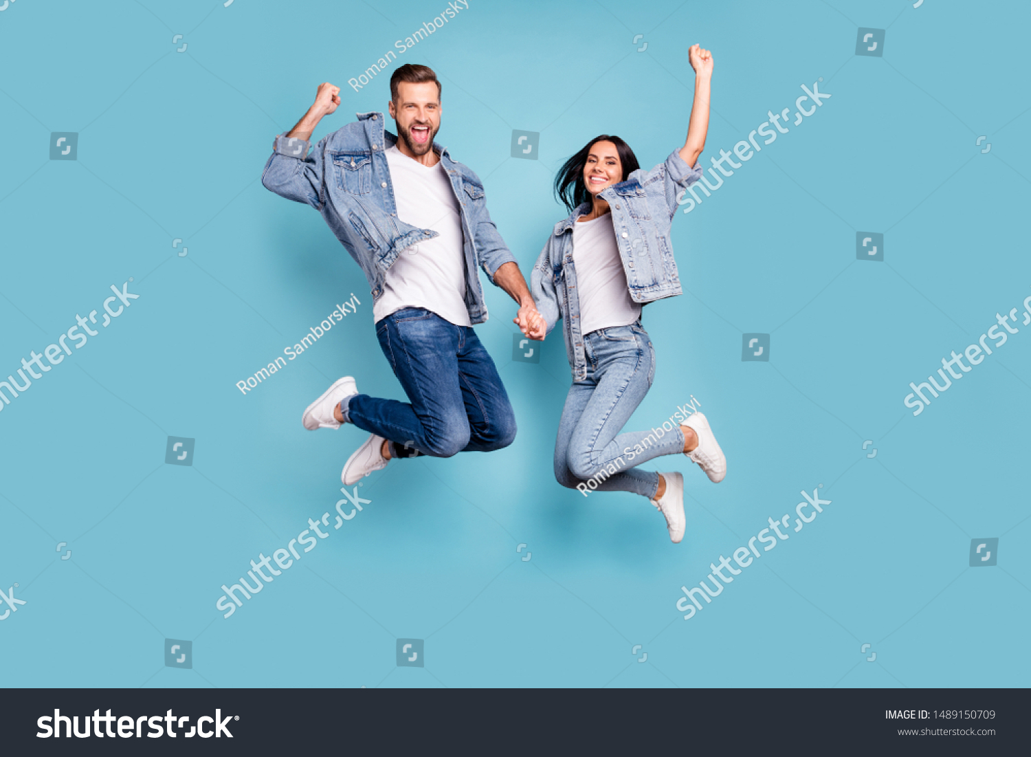 Photo of rejoicing overjoyed nice charming couple wearing jeans denim jackets enjoying their free time in summer while isolated with blue background #1489150709