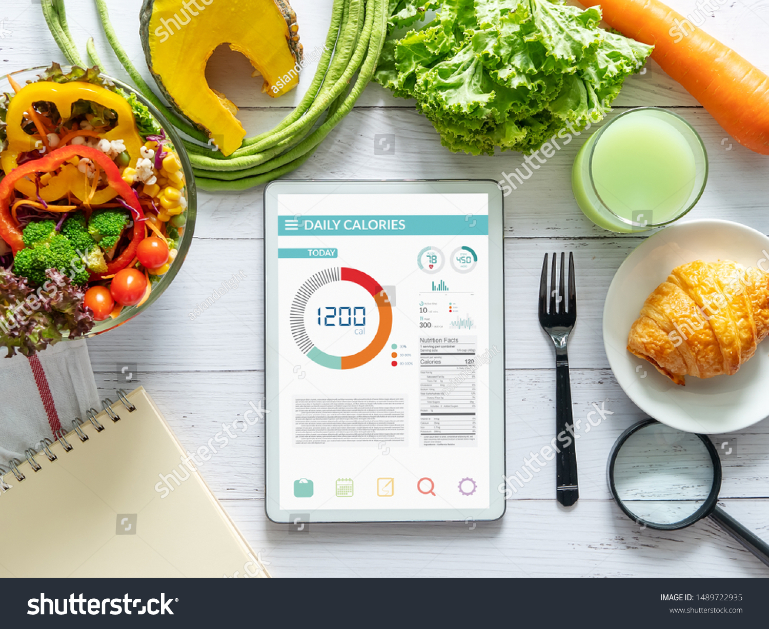 Calories counting, diet , food control and weight loss concept. tablet with Calorie counter application on screen at dining table with salad, fruit juice, bread and vegetable #1489722935