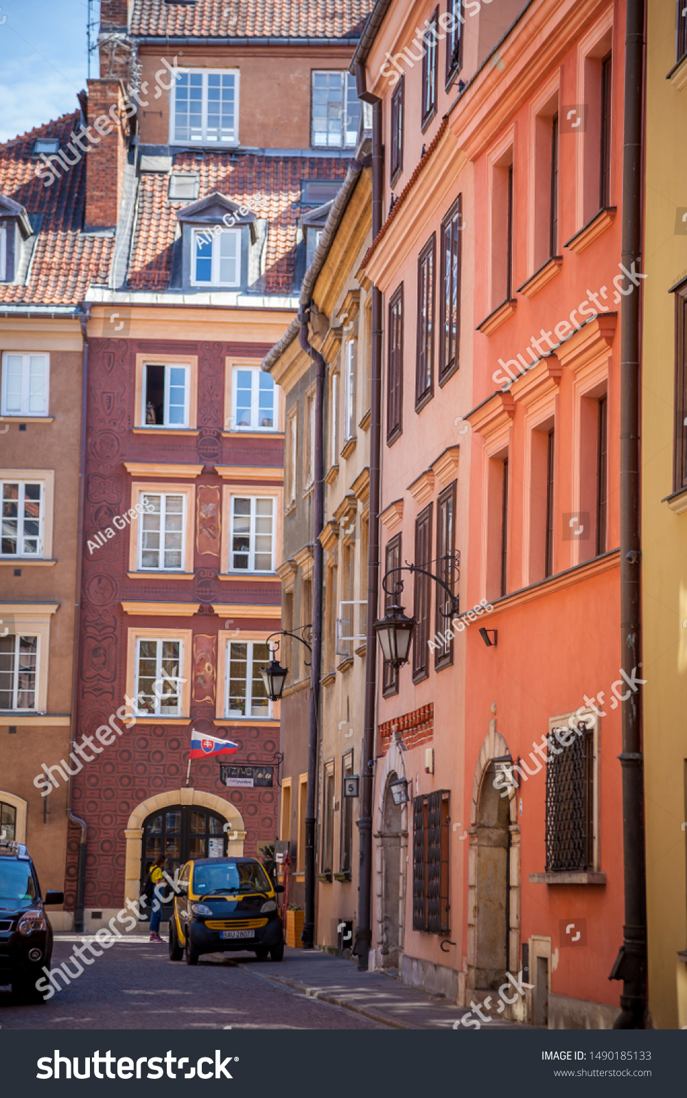 Warsaw, Poland - July 2, 2019: Streets of the old city. Polish ancient architecture. European city - tourist route attractions. Attraction - colorful houses, paving stones in the streets. #1490185133