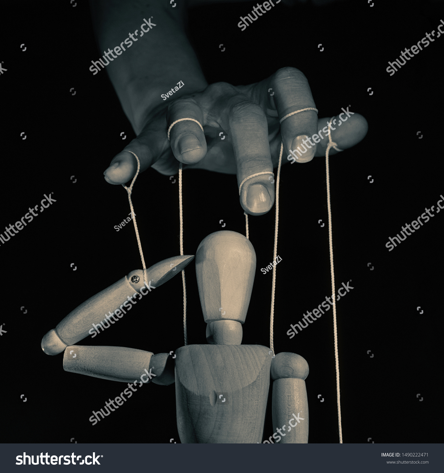 Concept of control. Marionette in human hand l, black and white. Image. #1490222471