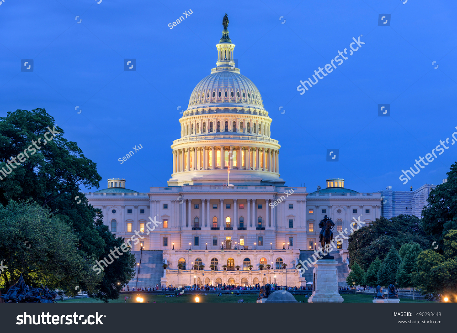 Summer Night at Capitol Hill - A dusk view of west-side of U.S. Capitol Building, as a small crowd gathering around a summer concert at front, Washington, D.C., USA. No recognizable log or person. #1490293448