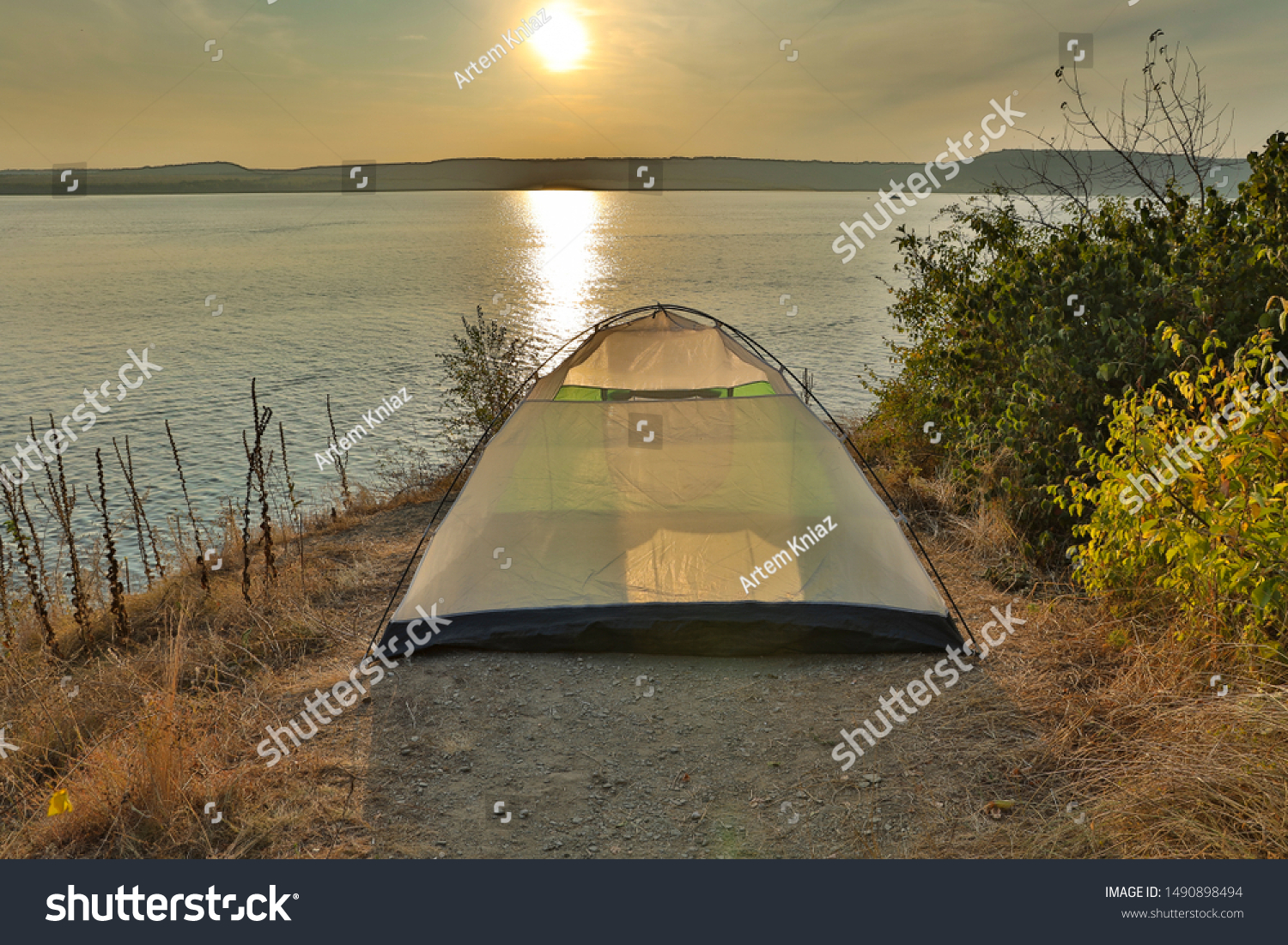 tourism and travel photography of tent stay on edge of cliff in nature reserve scenic environment with  lake water background in sunset time  #1490898494