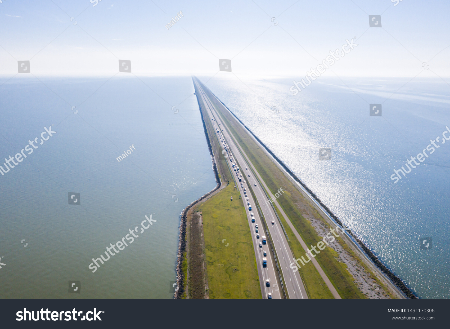 Afsluitdijk, a major dam and causeway in the Netherlands, runs from Den Oever in North Holland to village of Zurich in Friesland province, damming off the Zuiderzee, salt water inlet of the North Sea. #1491170306