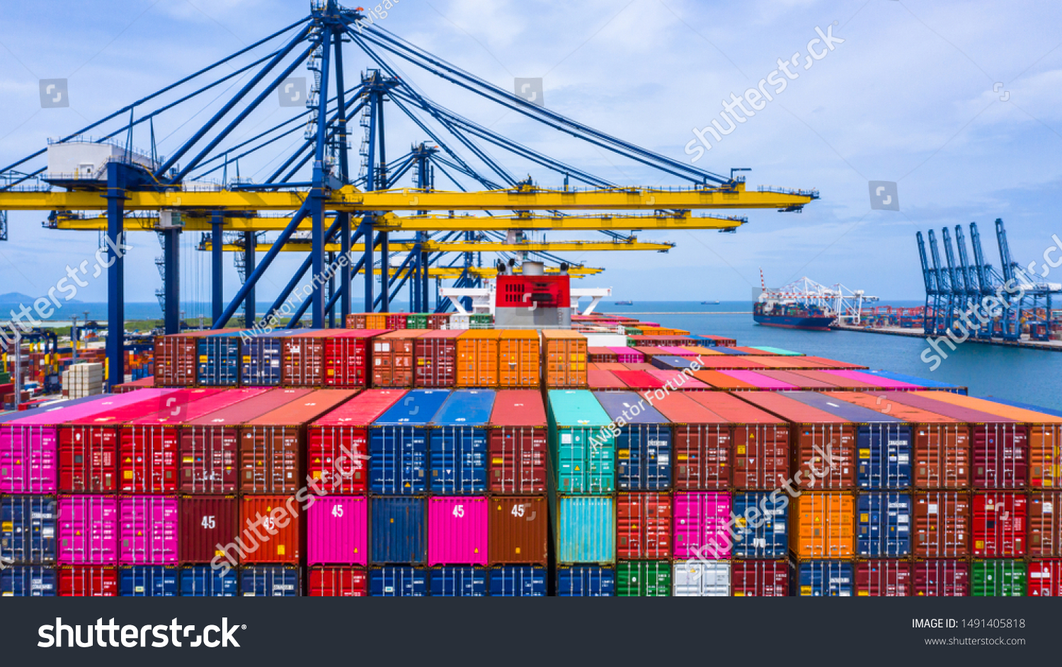 Container ship loading and unloading in sea port, Aerial view of business logistic import and export freight  transportation by container ship in harbor, Container loading Cargo freight ship, Dubai.