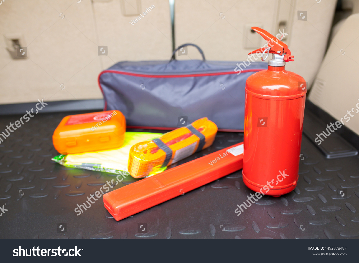 Set for a car from a fire extinguisher, tow rope, tool kit and medical kit in the trunk of an off-road vehicle. #1492378487