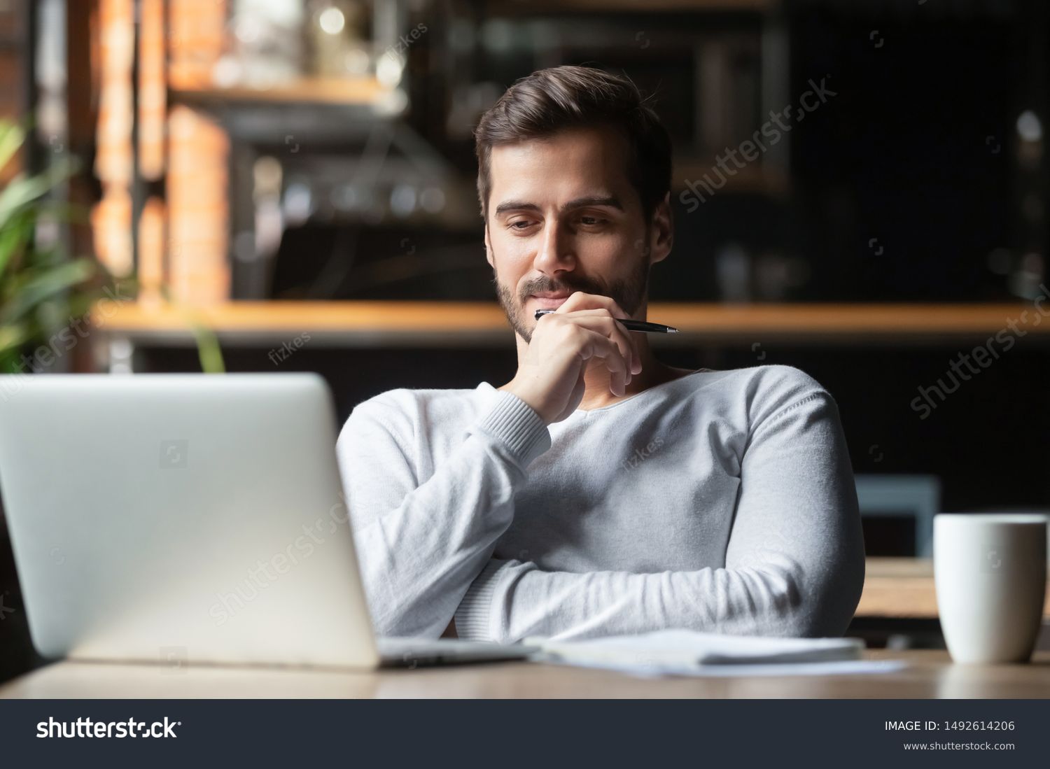 Thoughtful businessman think of online project looking at laptop at workplace, dreamy professional consider solution sit at work desk with computer, student search new idea inspiration in office cafe #1492614206
