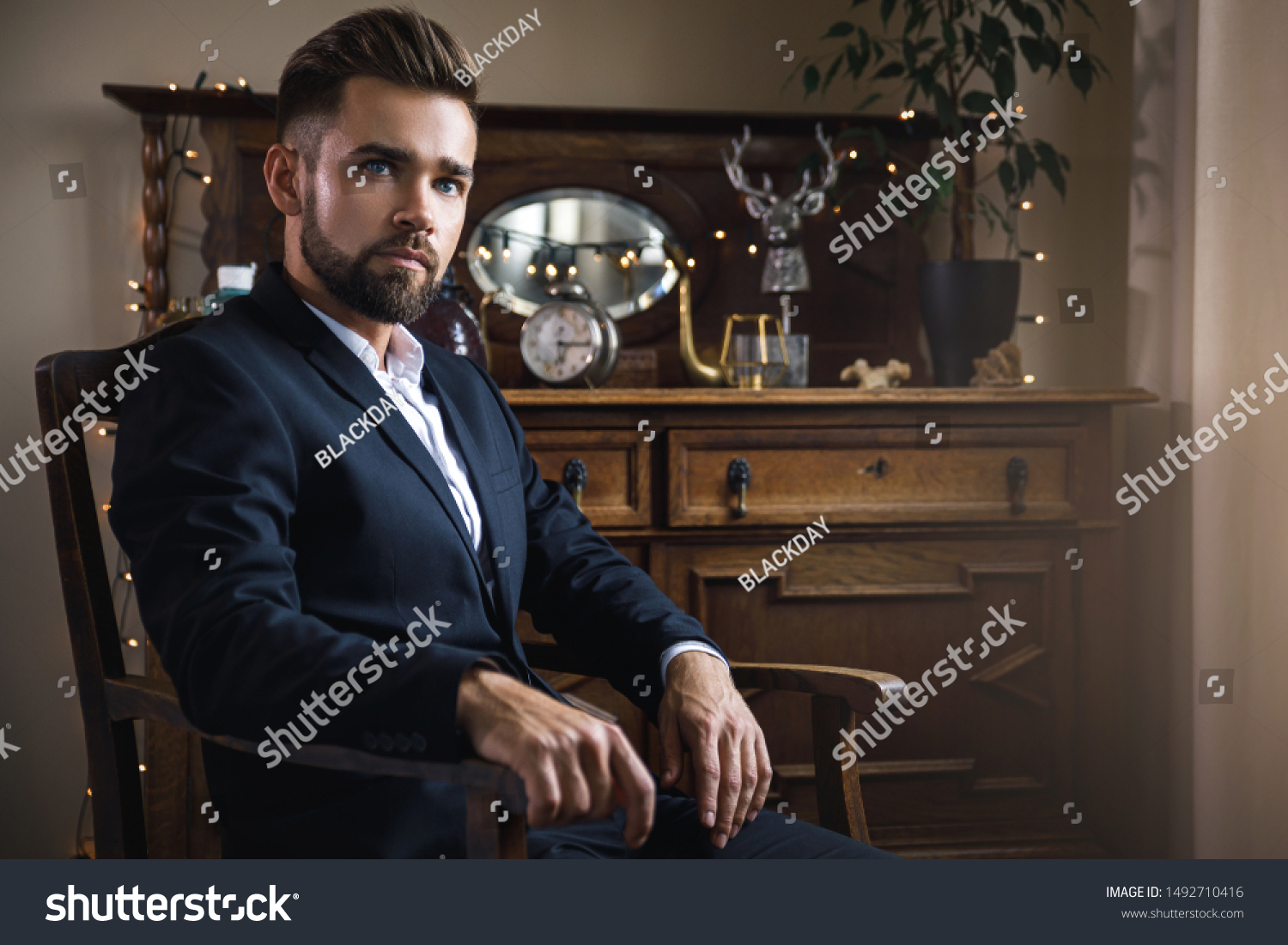 Portrait of handsome bearded man wearing black classic suit #1492710416