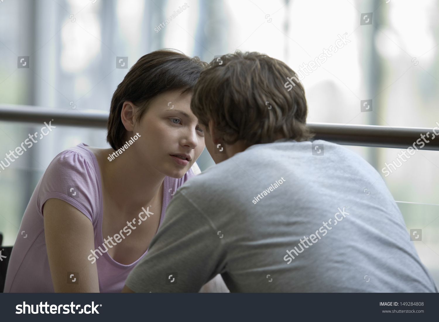 Young woman with man sitting in cafe of shopping center #149284808