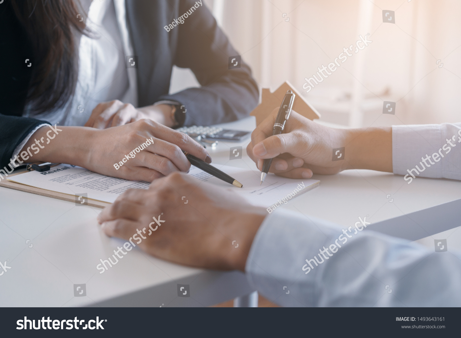 Salesmen are letting the male customers sign the sales contract, Asian women and men are doing business in the office, Business concept and contract signing #1493643161