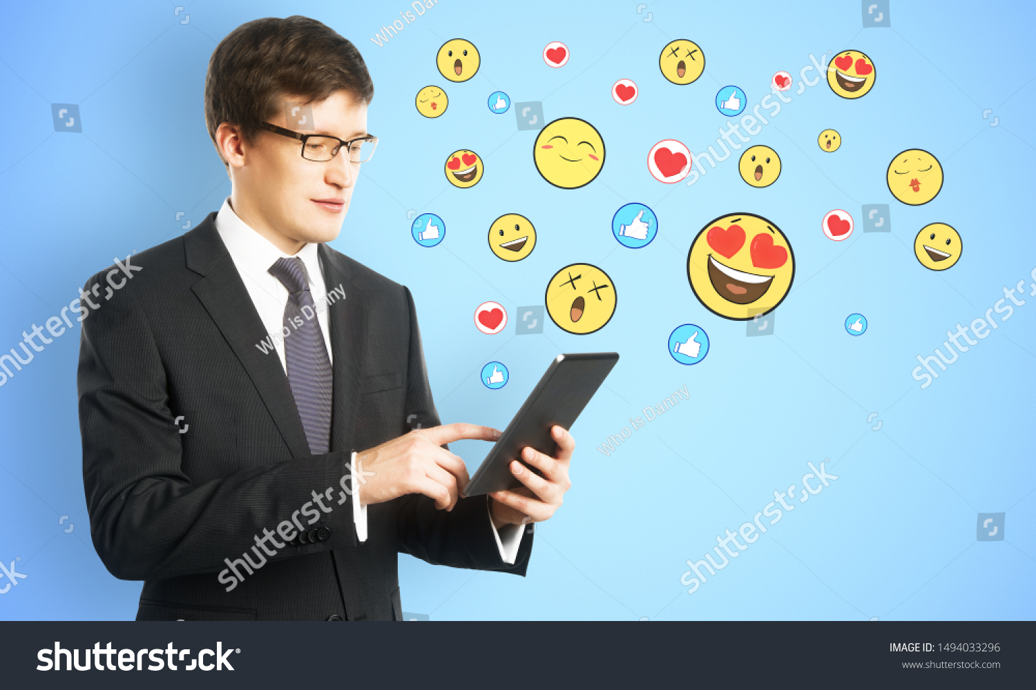 Portrait of handsome young businessman using tablet with emotive on subtle background. Communication and emotion concept #1494033296