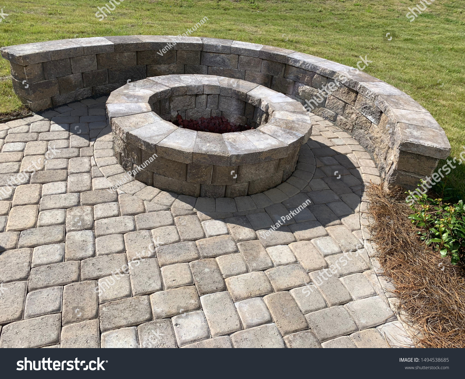 Backyard paver patio with stones and fire place #1494538685