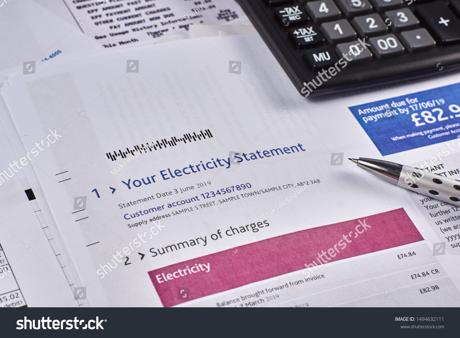 Electricity statement sheet with calculator and pen. Close-up #1494632111