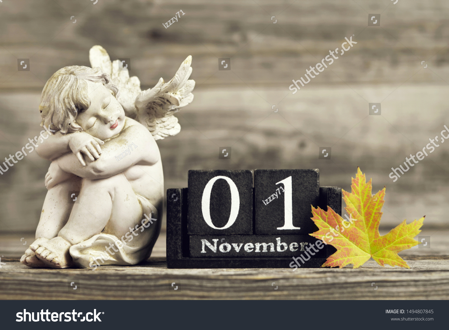 All Saints Day. Angel, wooden calendar and yellow autumn leaf #1494807845