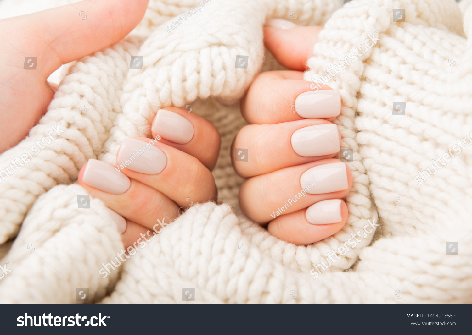 Stylish pastel beige Nails holding knitted wool material #1494915557