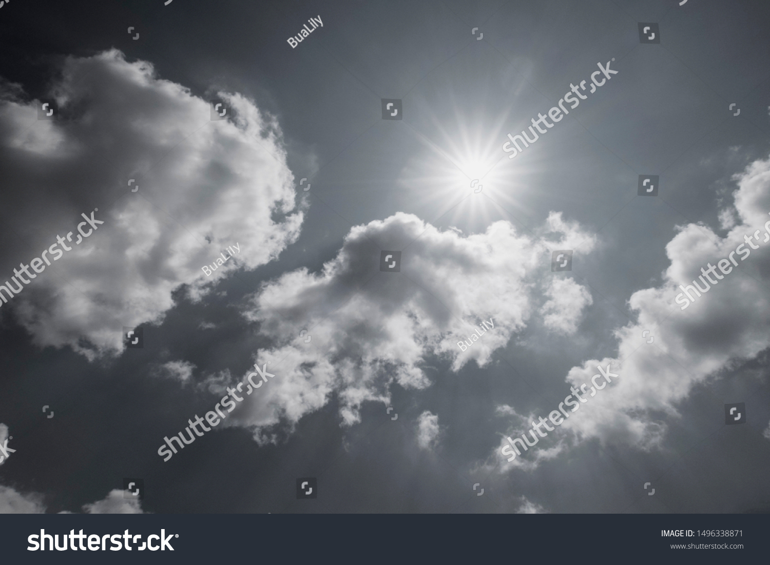 Black & white background - Angle view of beautiful natural sun ray & bright sunlight with lens flare on tropical sky & fluffy white clouds in tropical summer. Nature spectacular solar energy concept. #1496338871