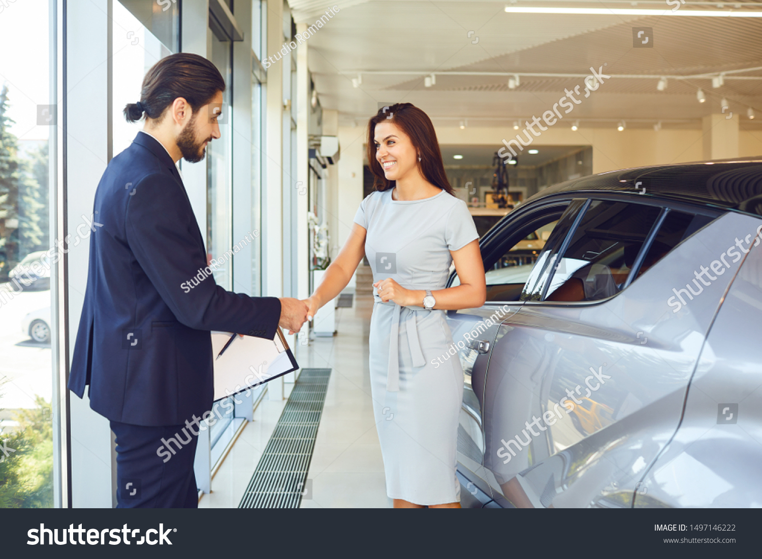Girl buyer shakes hands dealer car #1497146222