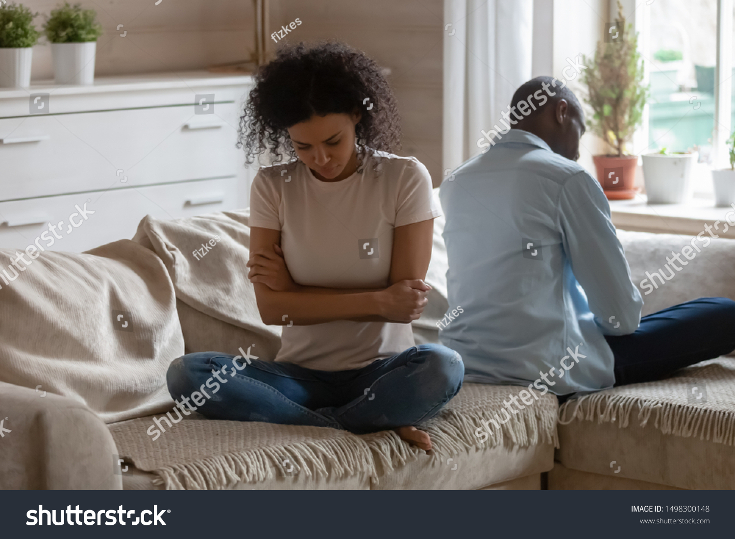 Stubborn african American husband and wife sit on couch back to back avoid talking after fight, mad offended biracial couple have family dispute or argument ignore each other, divorce concept #1498300148