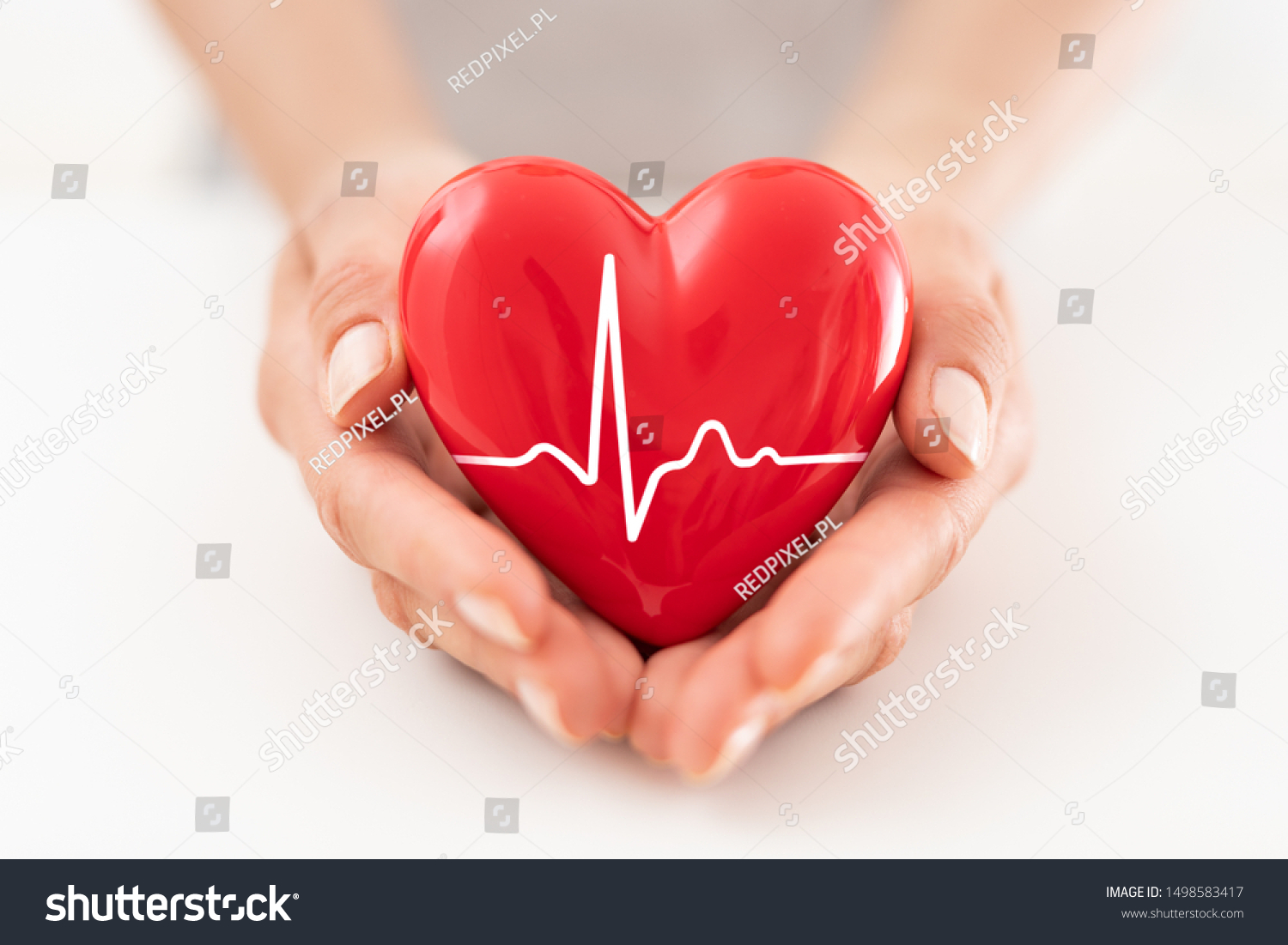 The woman is holding a red heart. Concept for charity, health insurance, love, international cardiology day. #1498583417