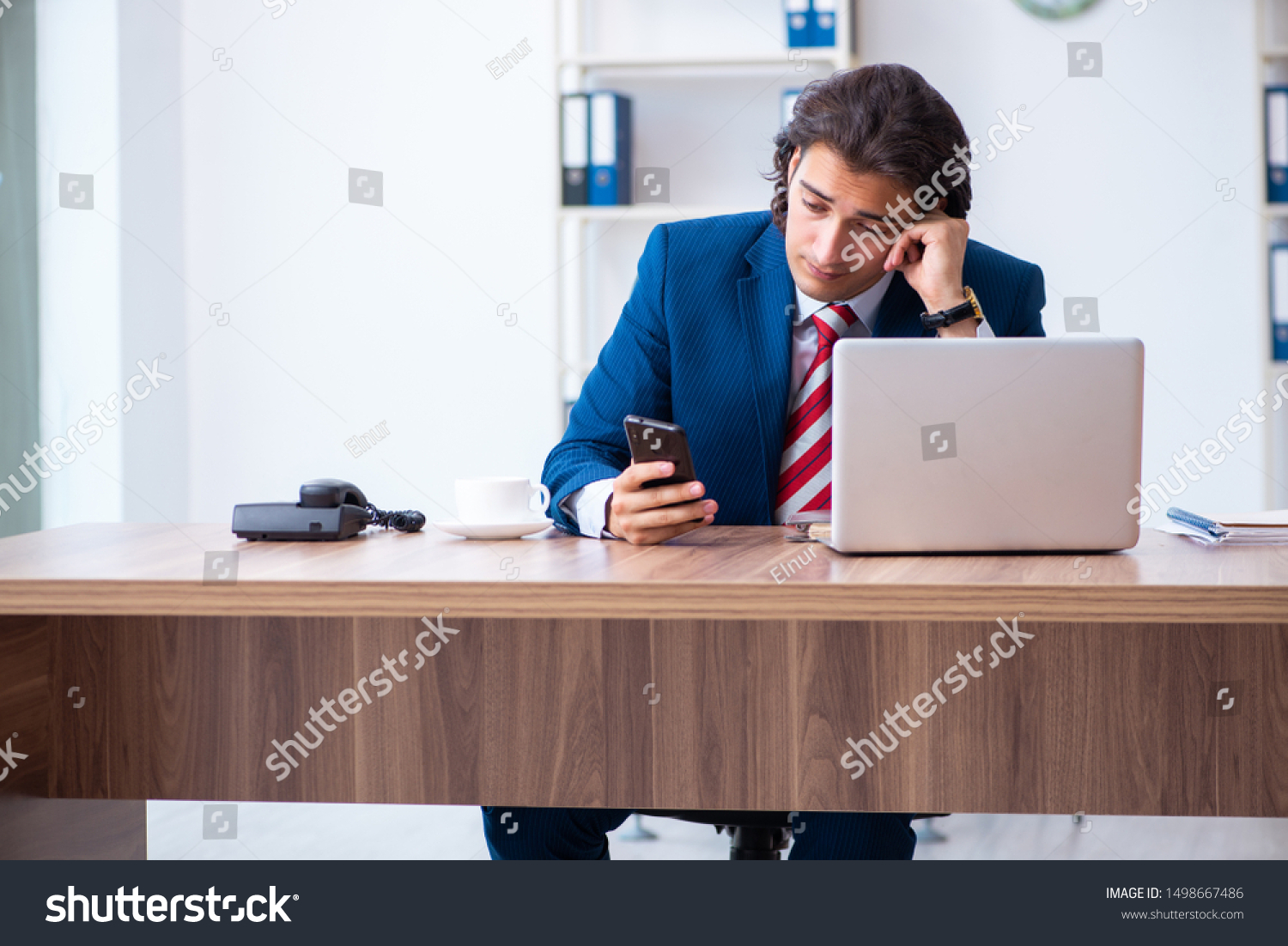 Young male businessman working in the office #1498667486