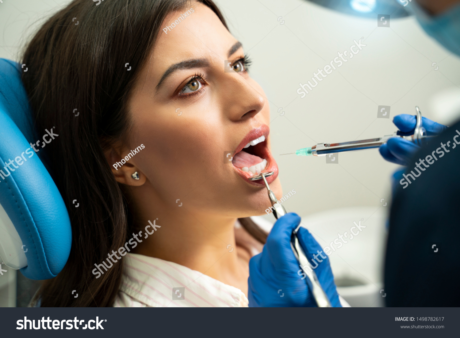 Young beautiful young adult woman getting dental anesthesia, closeup shot #1498782617