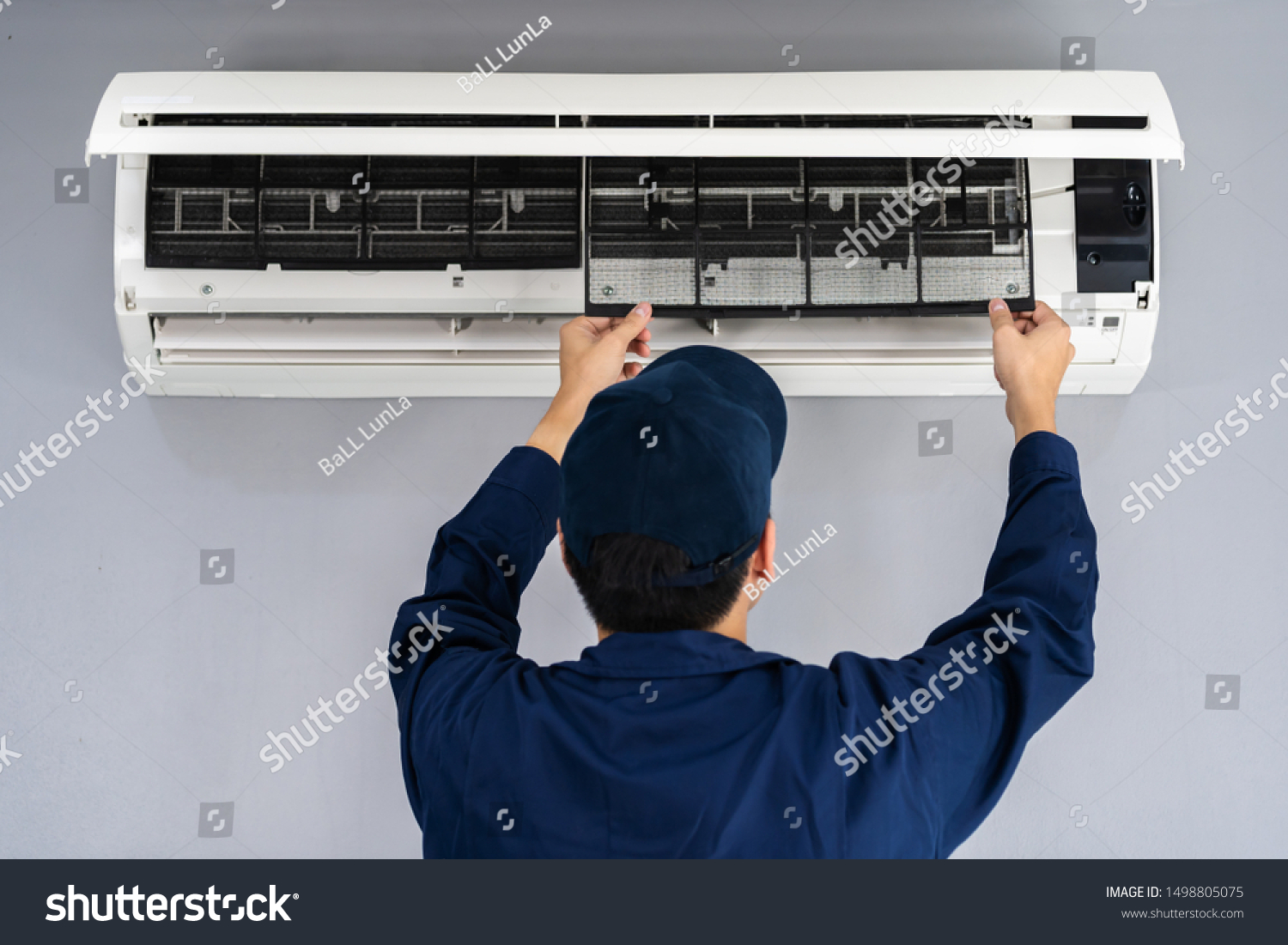 technician service removing air filter of the air conditioner for cleaning #1498805075