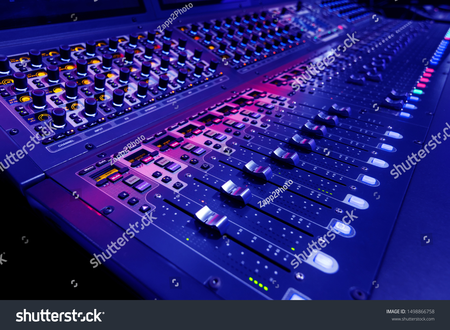 Professional audio studio sound mixer console board panel with recording , faders and adjusting knobs,TV equipment. Blue tone and close-up image. #1498866758