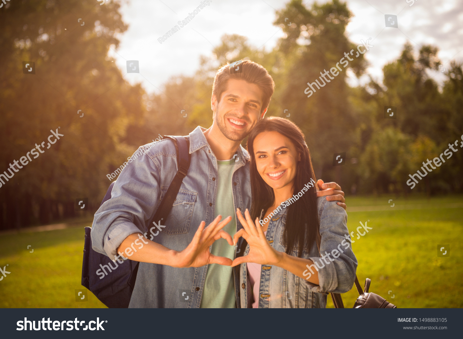 Portrait of his he her she nice attractive cheerful sweet tender amorous affectionate married spouses tourists showing heart shape gathering in green wood forest shiny day sun light #1498883105