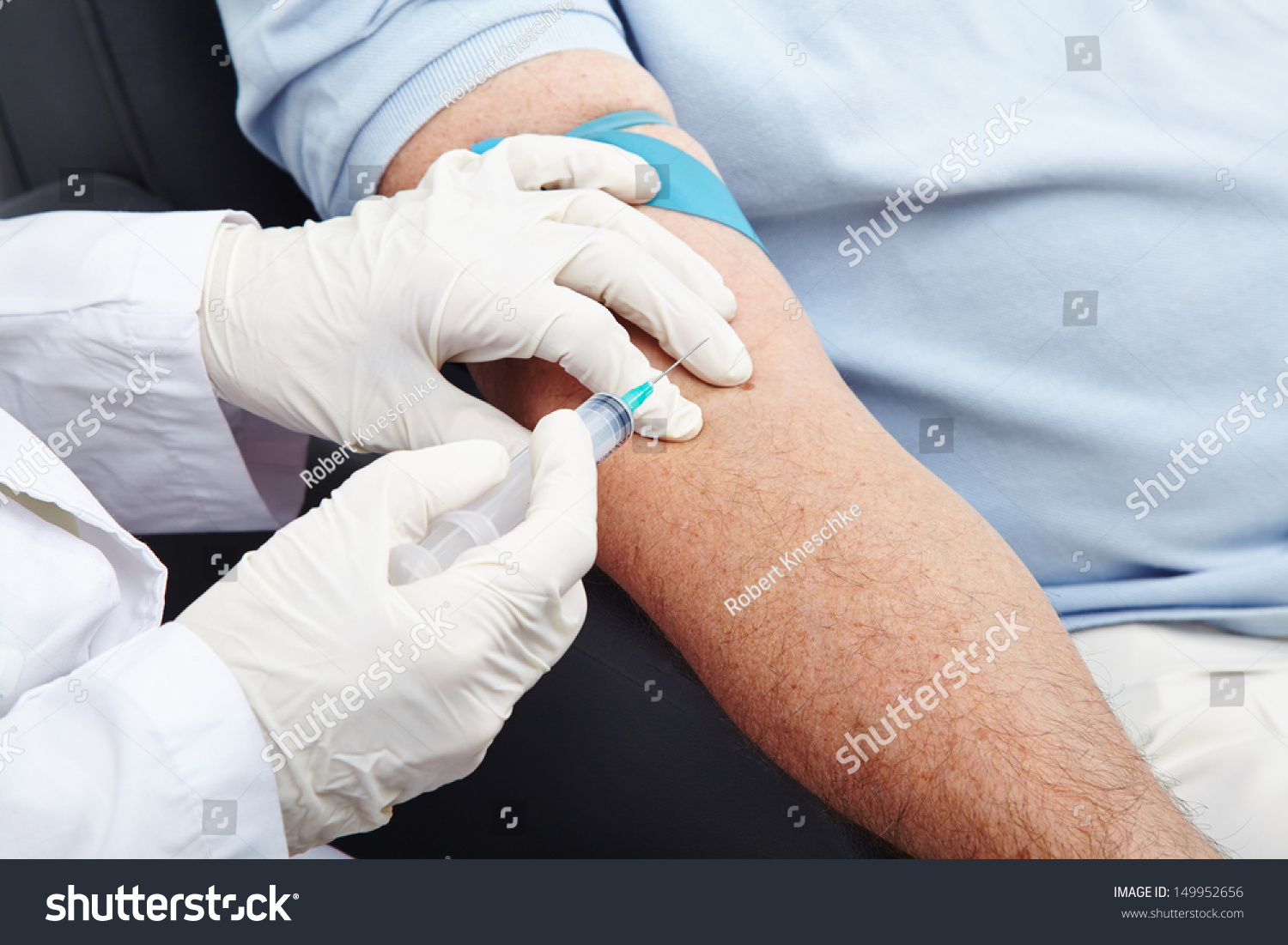 Man giving blood donation with syringe in his arm #149952656