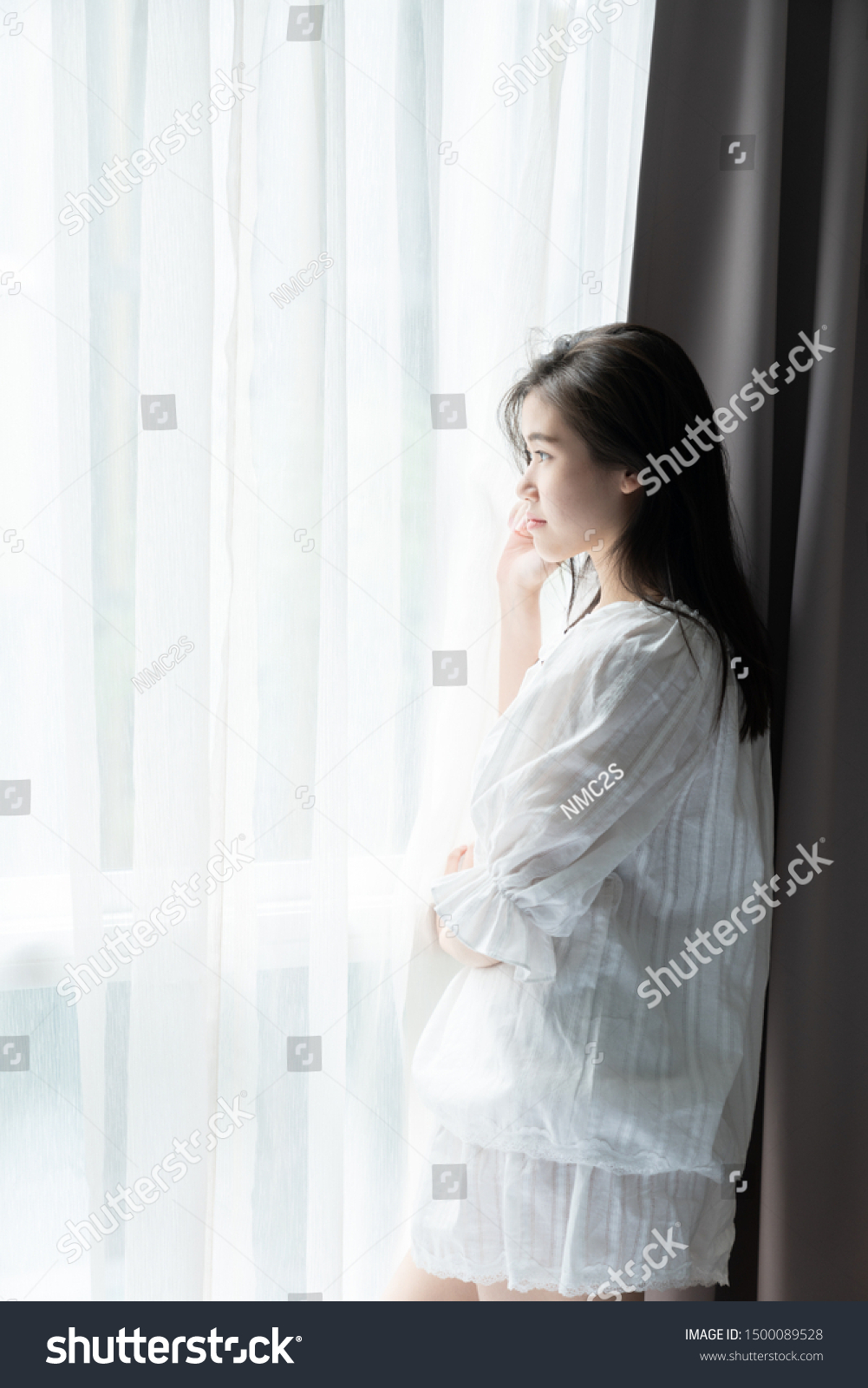 Women standing near window in the morning /thinking concept/ morning activities #1500089528