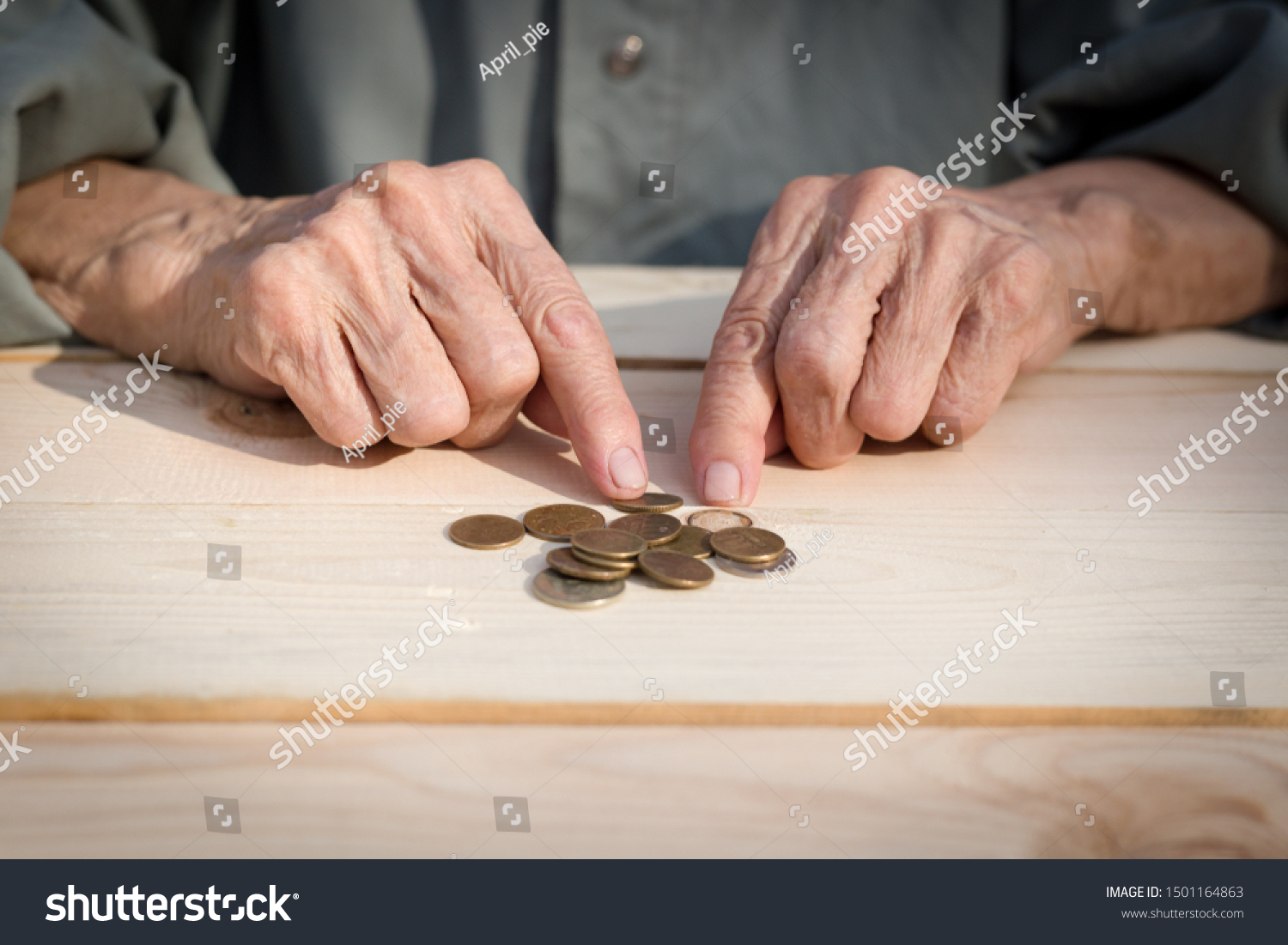 Hands of an elderly man holding coins. The concept of lack of money, the poor, the small pension of old people. Image. #1501164863